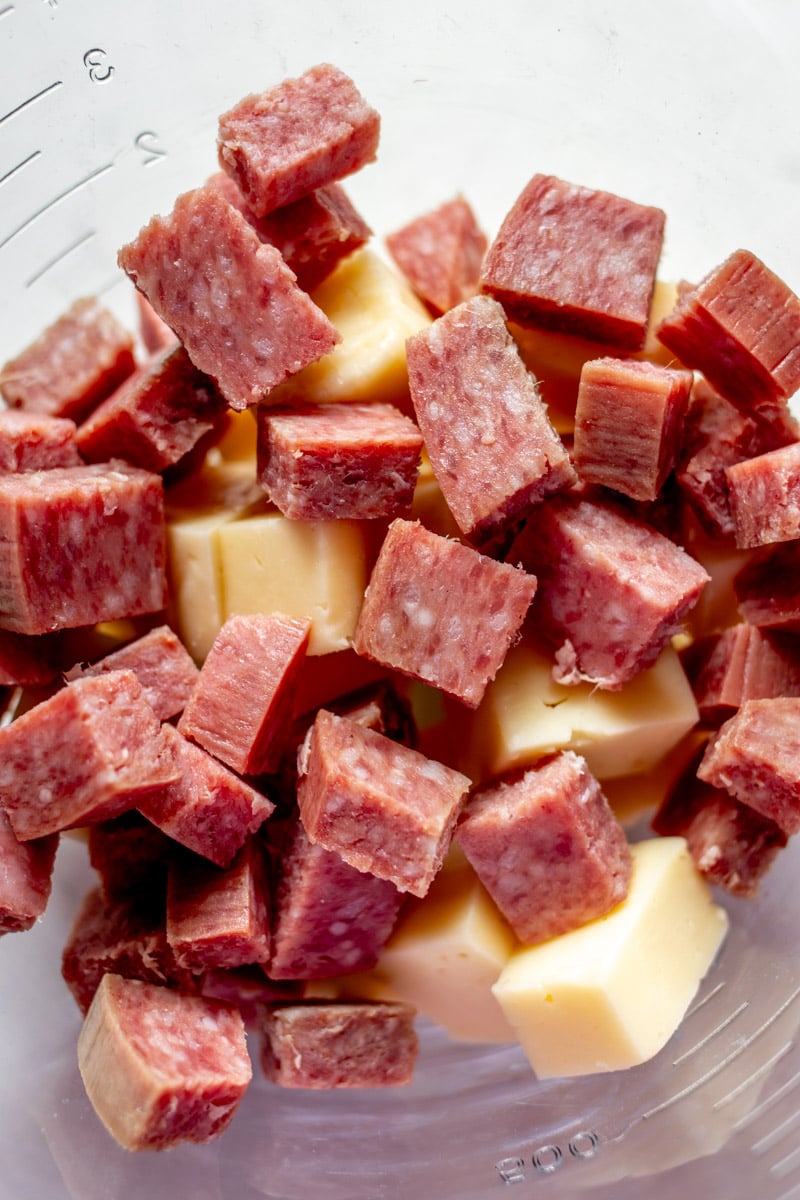 cubes of salami and cheese in a glass bowl. 