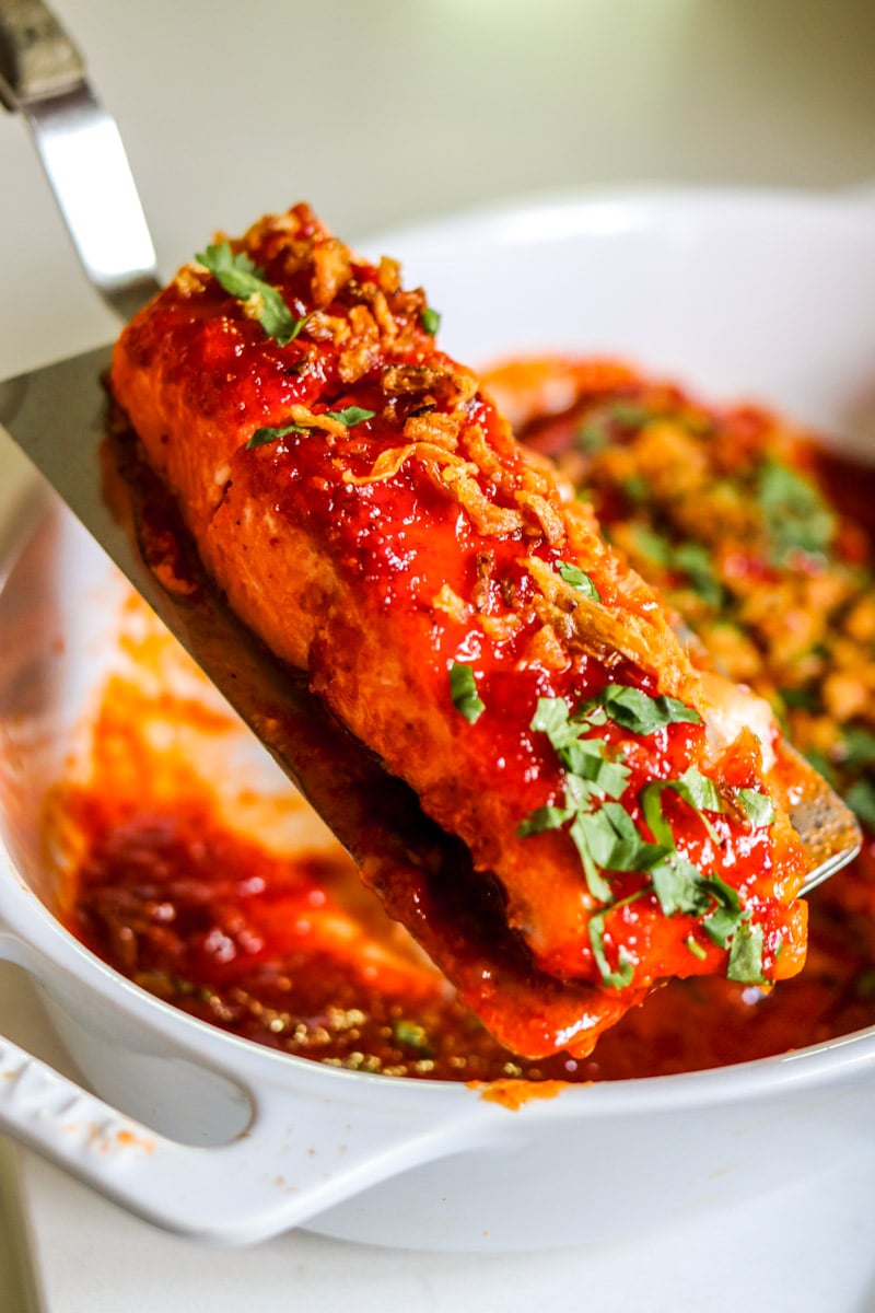 a piece of spicy salmon on a silver spatula. 