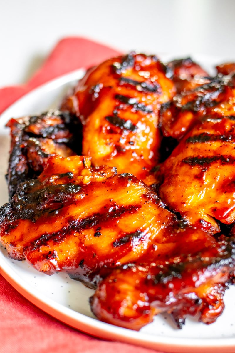 the right side of a white plate filled with bbq chicken. 