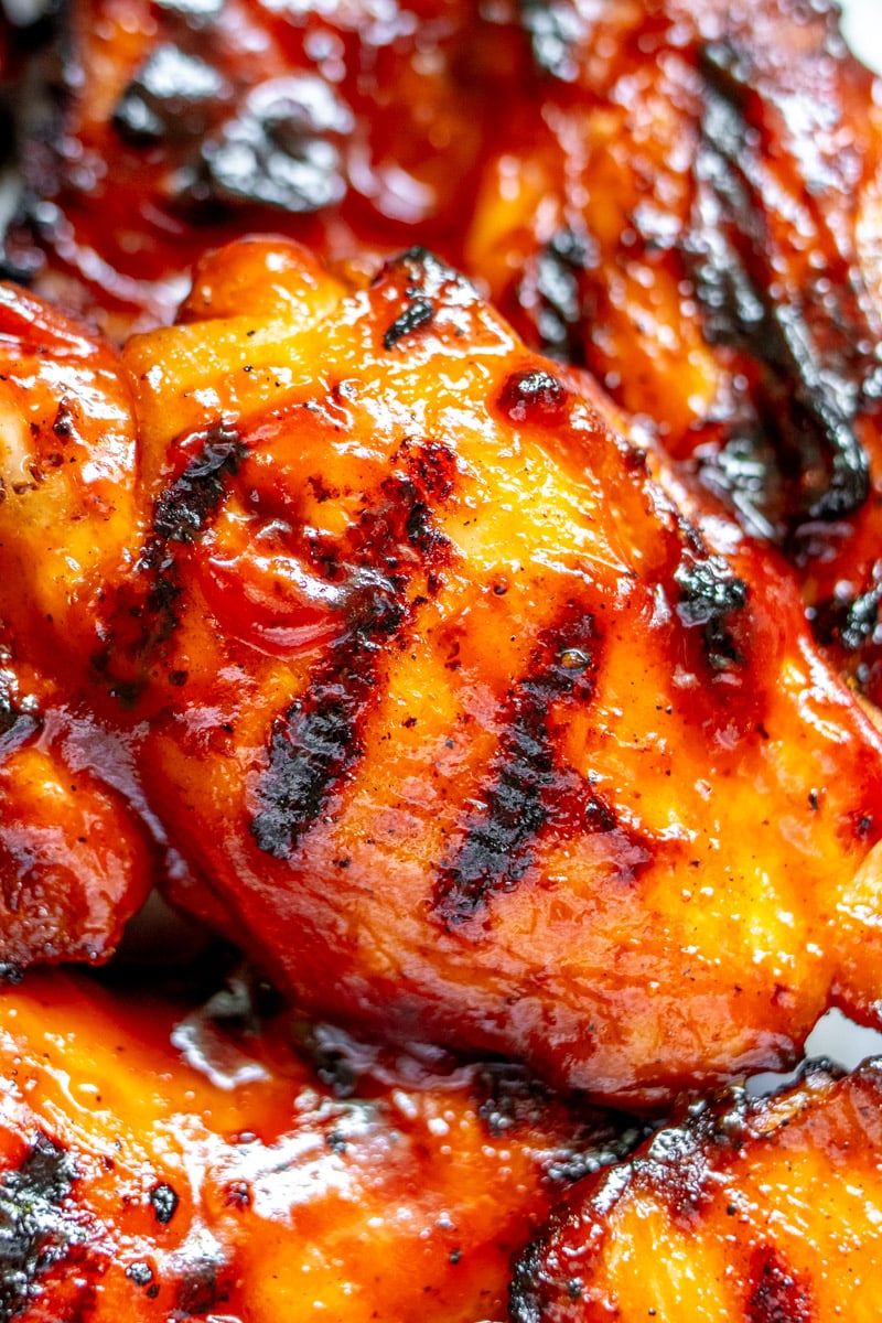 an up close macro view of the grill marks on bbq chicken thighs. 