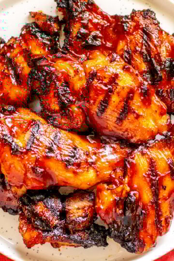 BBQ Chicken Thighs on a white plate.