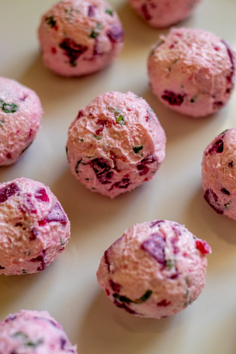 goat cheese balls rolled up on a plate.