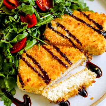 two pieces of fried feta with balsamic drizzle on top.