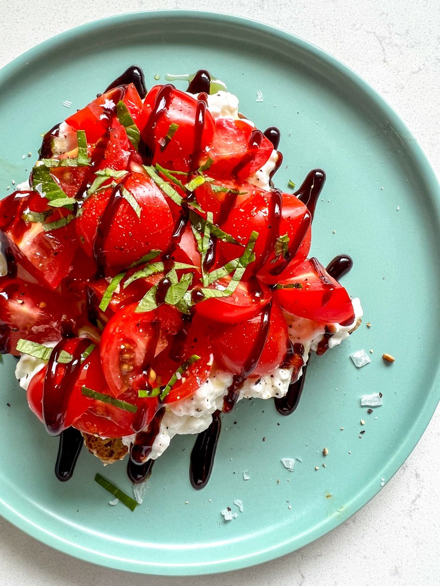 bruschetta on top of a slice of cottage cheese toast.