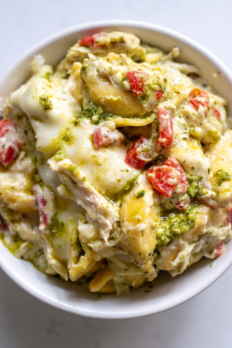 an overhead view of a bowl of cheesy chicken tortellini casserole. 