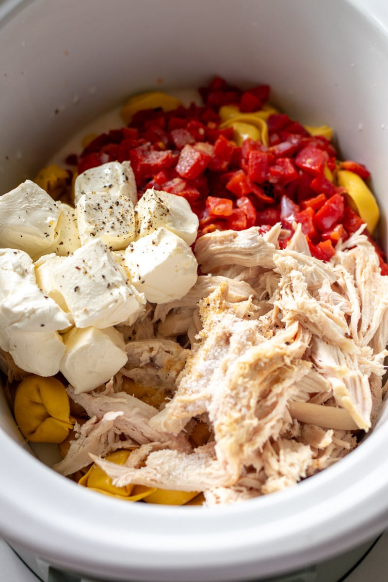 chicken, cream cheese, tortellini and roasted red peppers in a crockpot. 