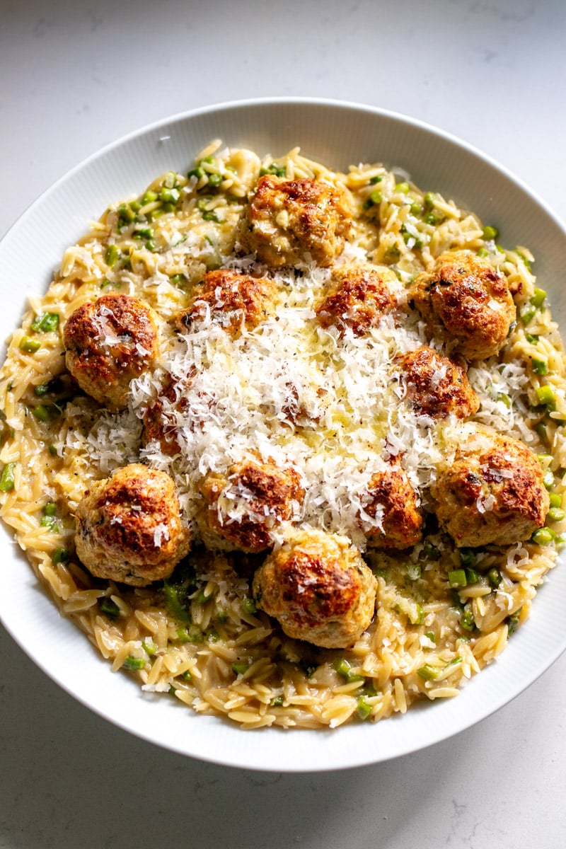 a big white serving platter full of boursin chicken meatballs and orzo