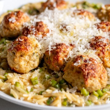 boursin chicken meatballs with orzo in a white serving bowl.