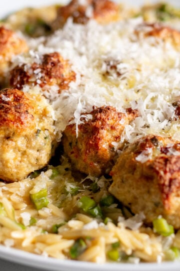 boursin chicken meatballs with orzo in a white serving bowl.