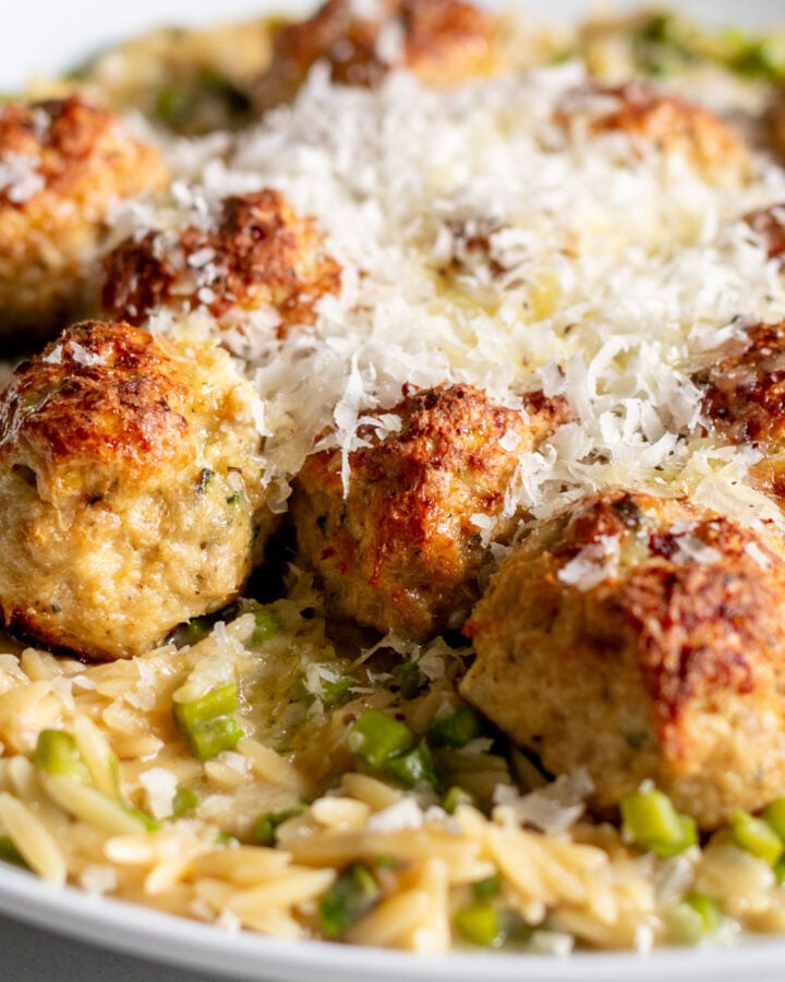 boursin chicken meatballs with orzo in a white serving bowl.