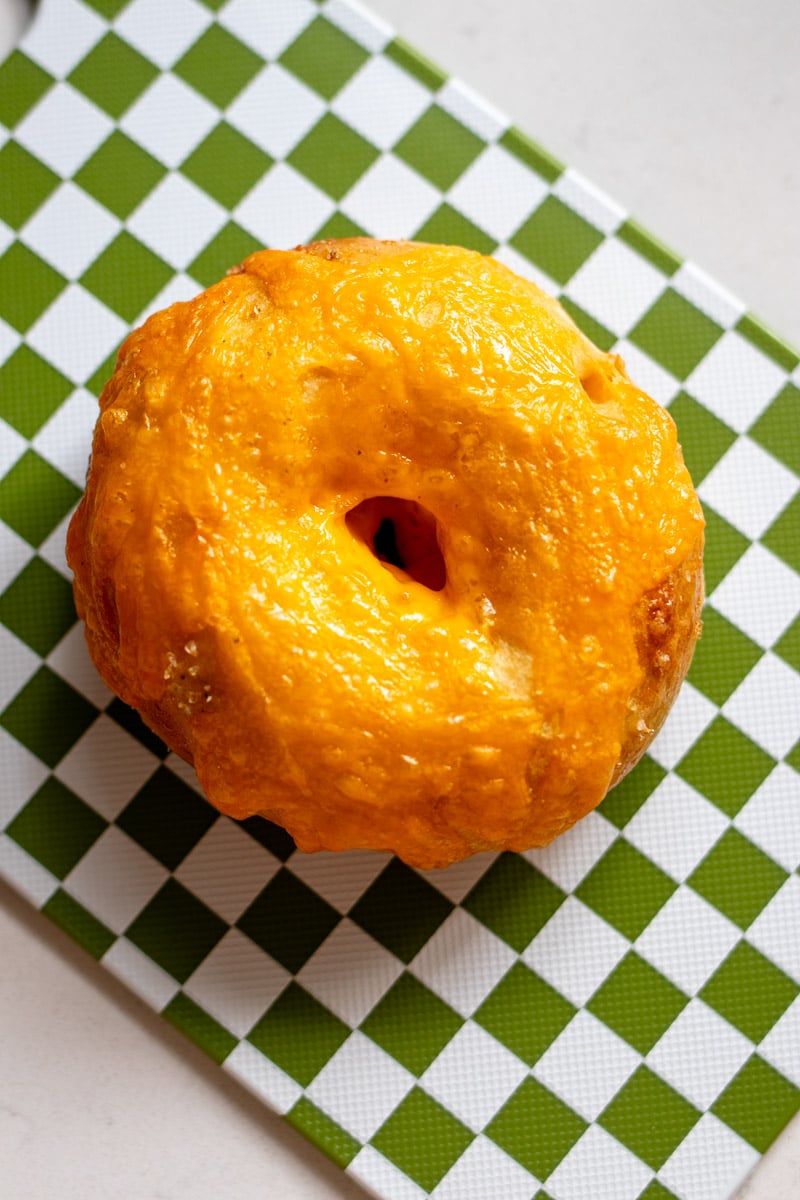 an overhead shot of a single broccoli cheese crescent roll bagel.