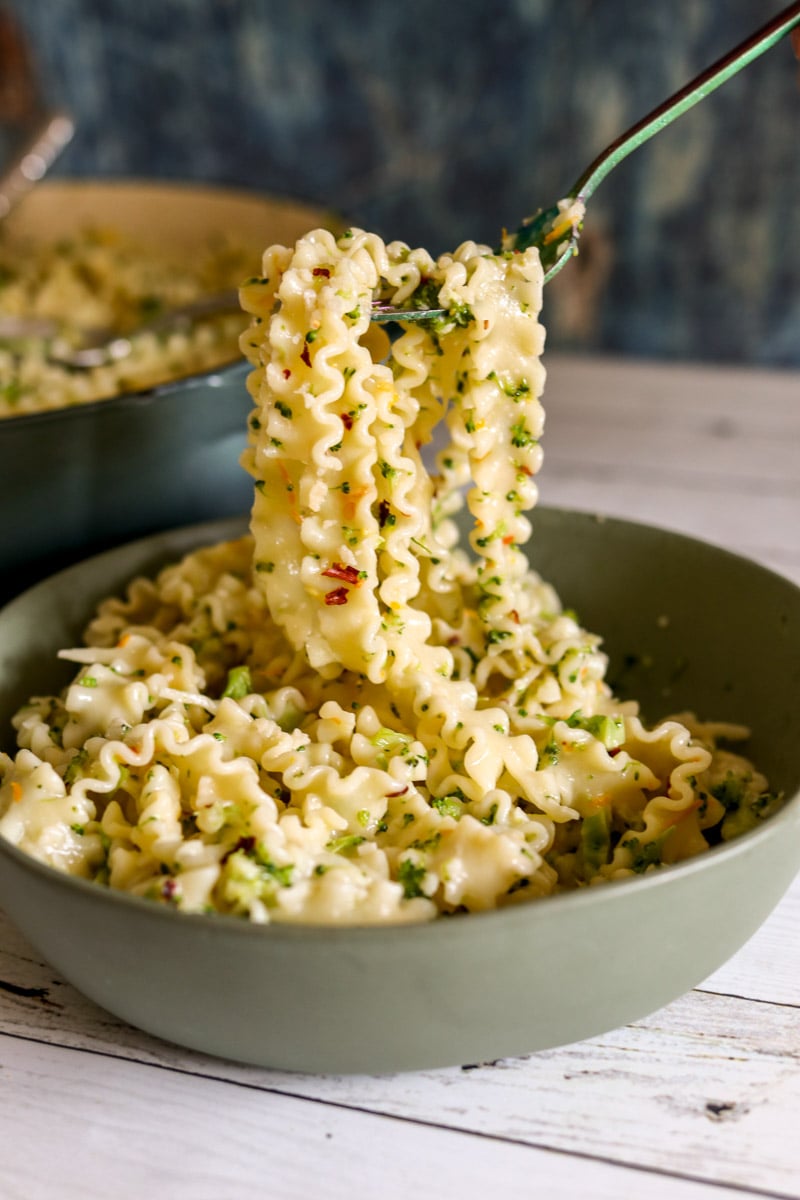 a fork holding a scoop of broccoli pasta. 