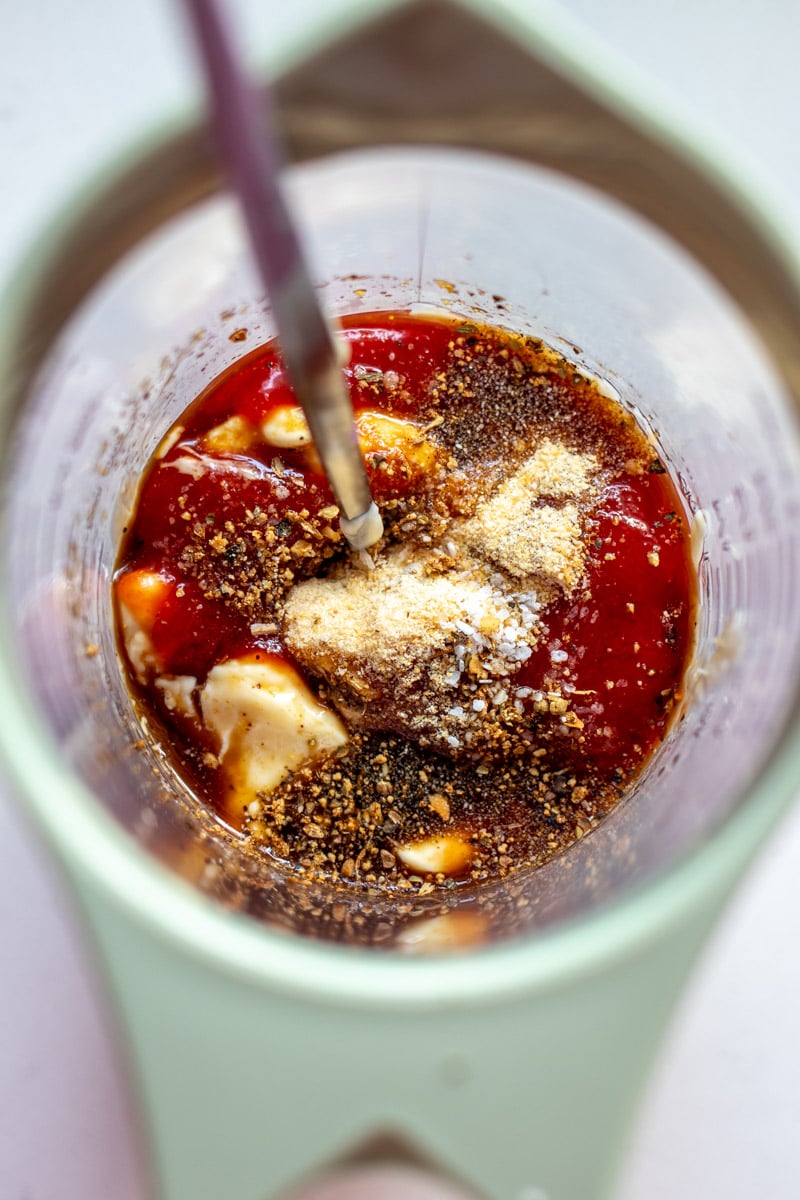 ingredients of raising cane's sauce in a measuring cup.