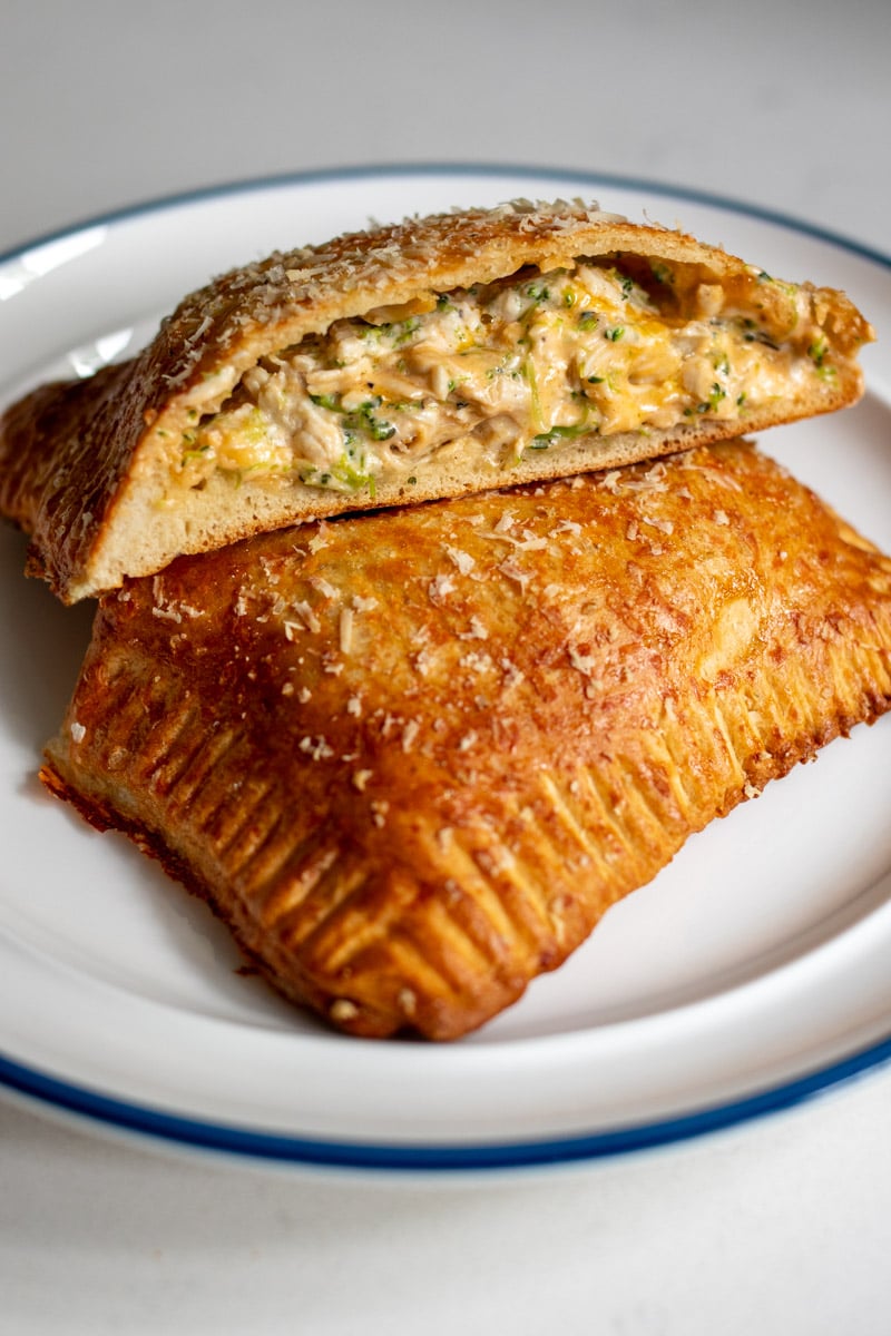 a cheddar broccoli chicken hot pocket cut open on a plate.