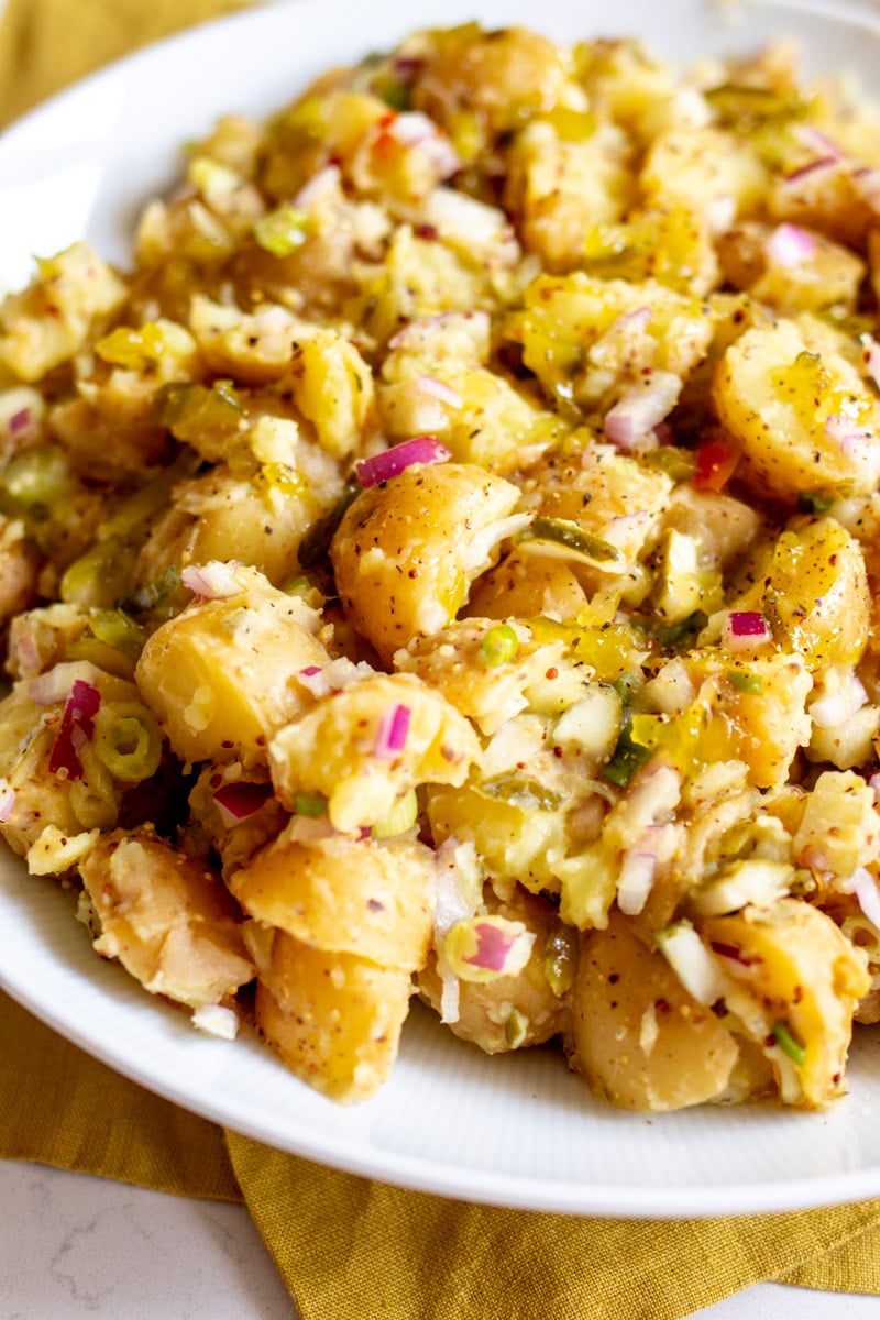 the bottom left side of a white bowl filled with a summertime favorite.