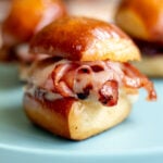 a single mini fried mortadella slider on a blue plate.