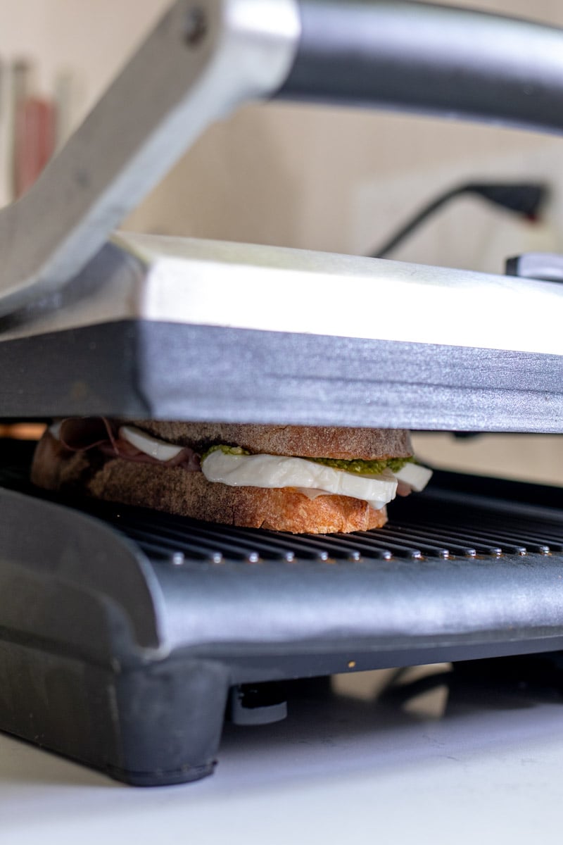 a panini being grilled on a panini press.