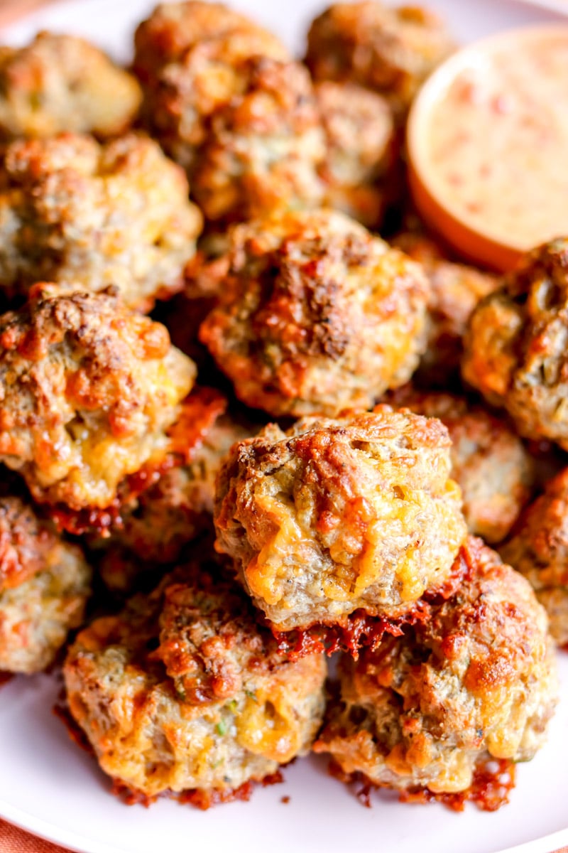 an up close view of some cream cheese sausage balls in a serving platter.