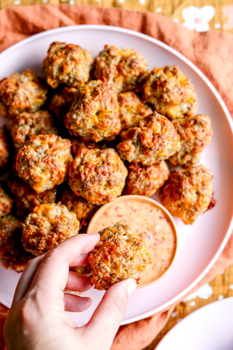 the right side of a platter of sausage balls with dipping sauce.