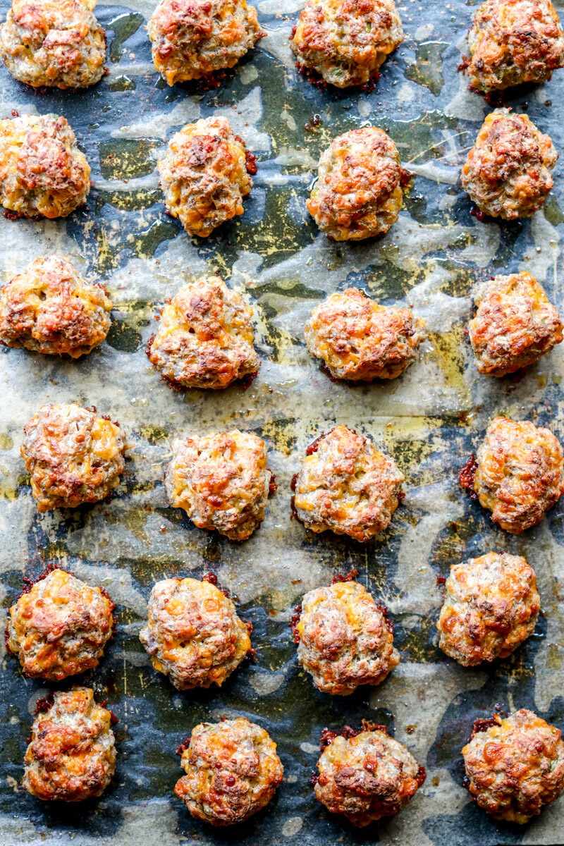 sausage balls on a parchment lined baking sheet.