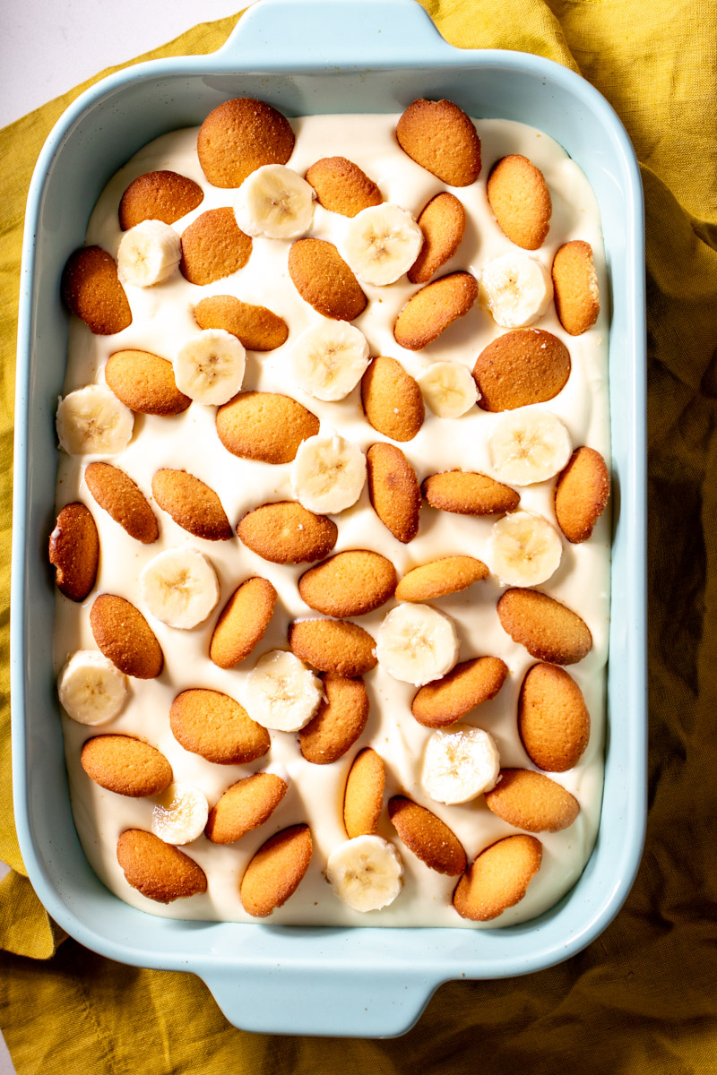 a giant tub of southern banana pudding on a yellow napkin.