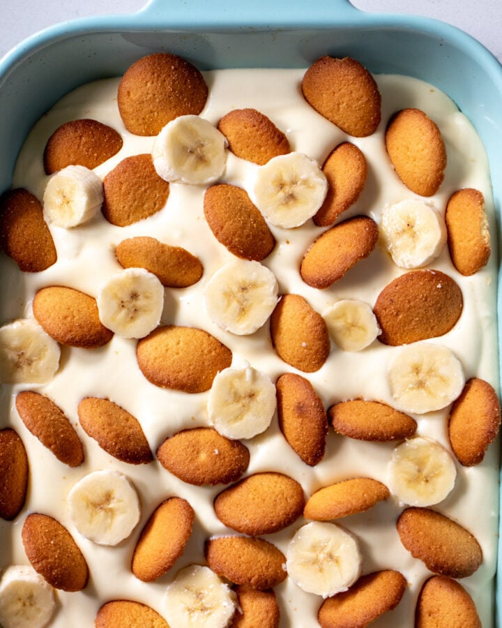 southern banana pudding in a blue serving platter with nilla wafers and banana slices.