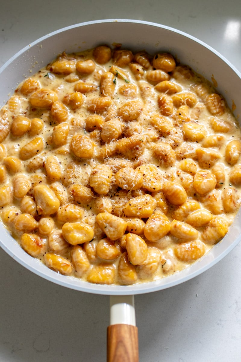 a large nonstick skillet filled with creamy gnocchi.