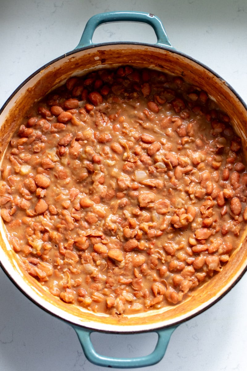 a big blue braising pot of southern brown beans recipe. 