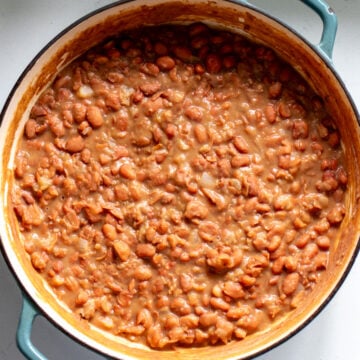 overhead view of brown beans cooked in a blue pot.