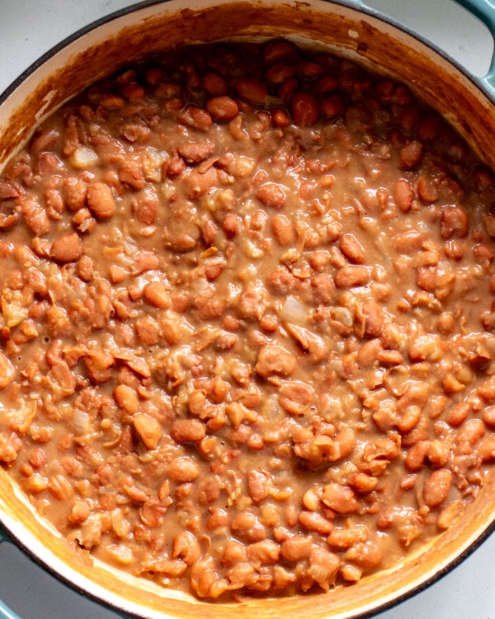 overhead view of brown beans cooked in a blue pot.