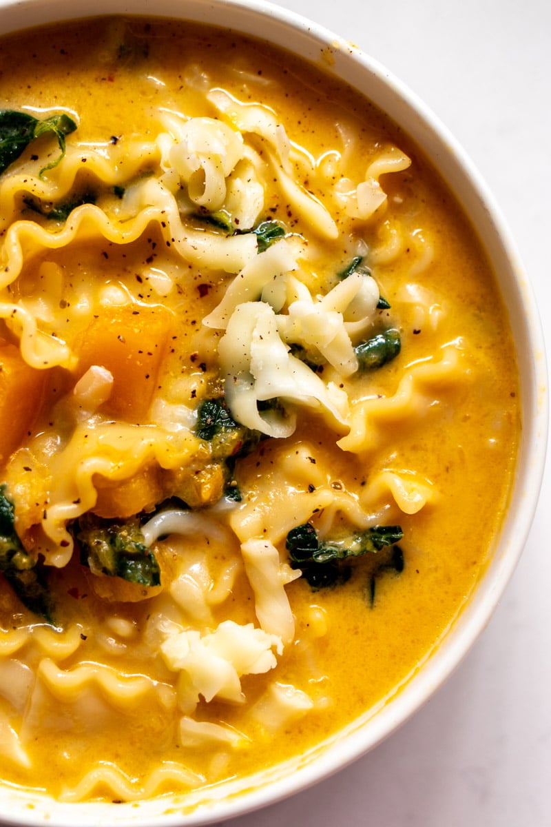 the right side of a bowl of lasagna soup with butternut squash and kale.