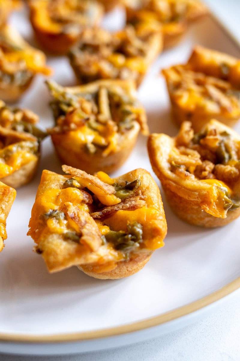 mini green bean casserole appetizer bites on a white platter.