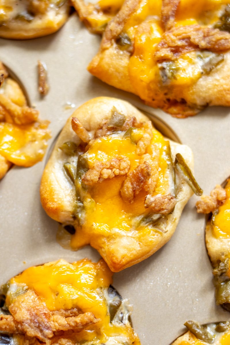 an up close view of a baked mini green bean casserole in a mini muffin tin. 