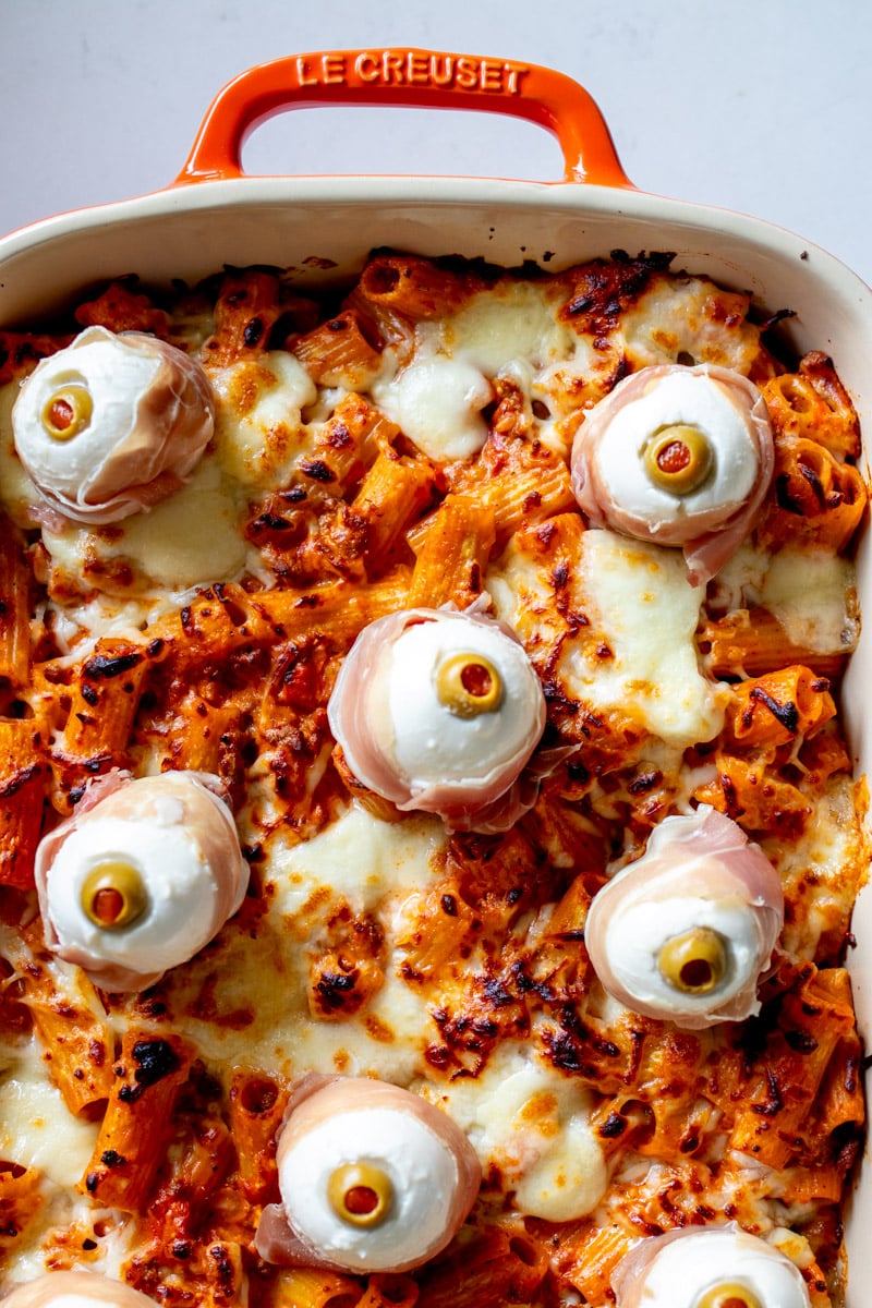 the top half of a baking dish filled with halloween pasta.