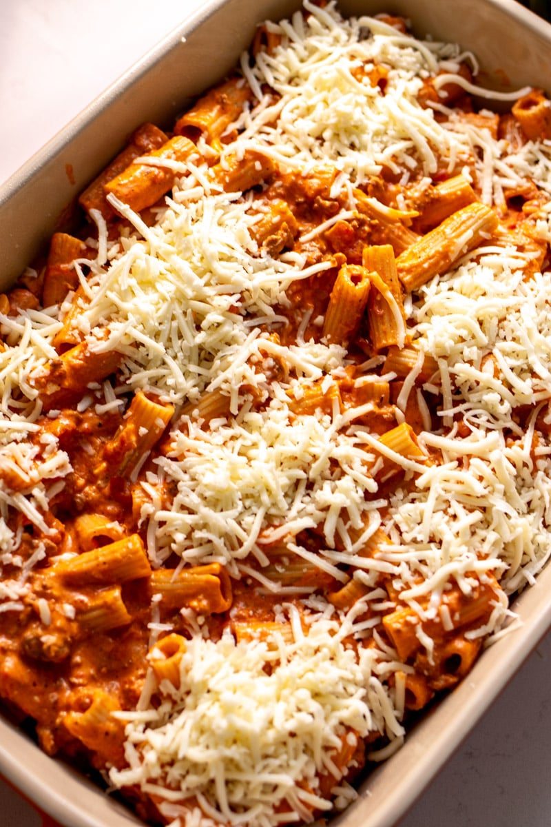 baked ziti before getting baked in a large cream baking dish.