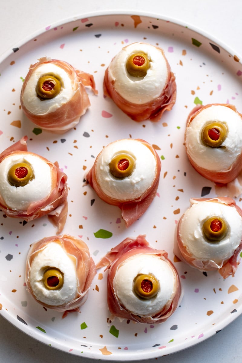 a plate full of spooky mozzarella eyeballs.