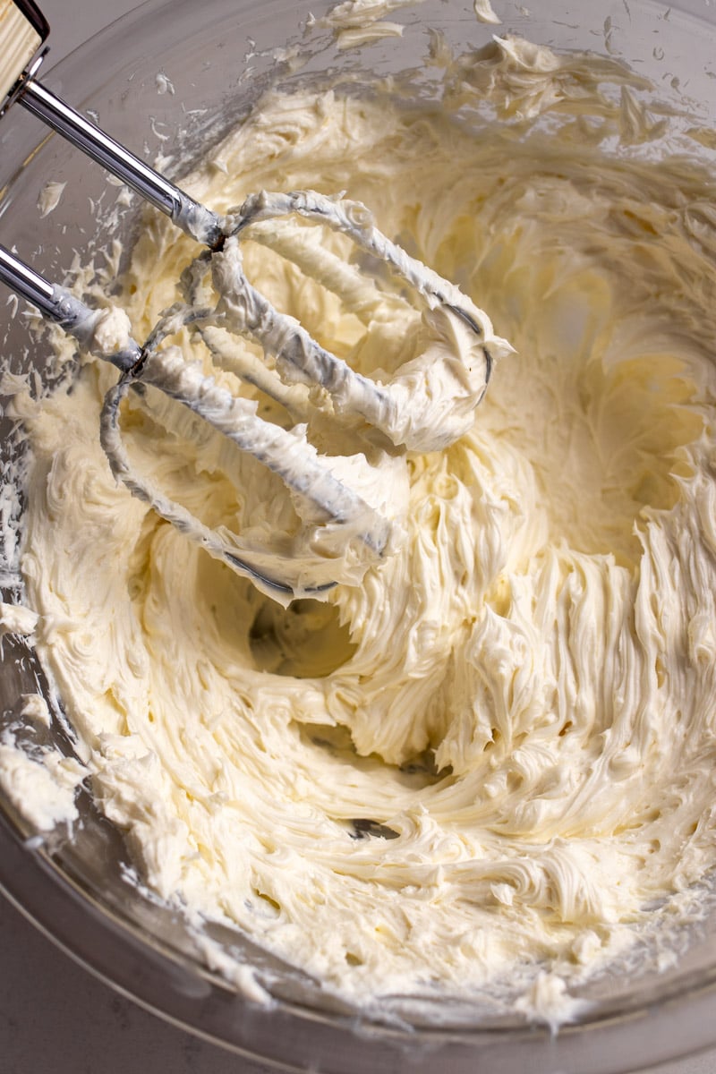 whipped goat cheese in a glass mixing bowl.