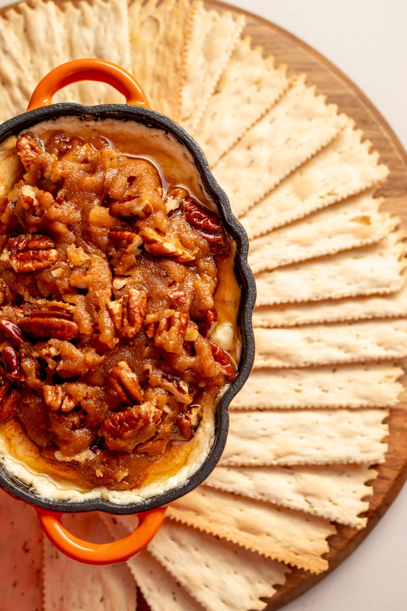 pecan pie goat cheese dip with rosemary crackers around it. 