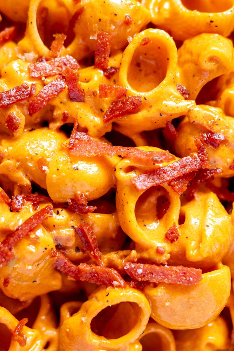 an up close view of pasta being tossed with pepperoni alla vodka sauce.