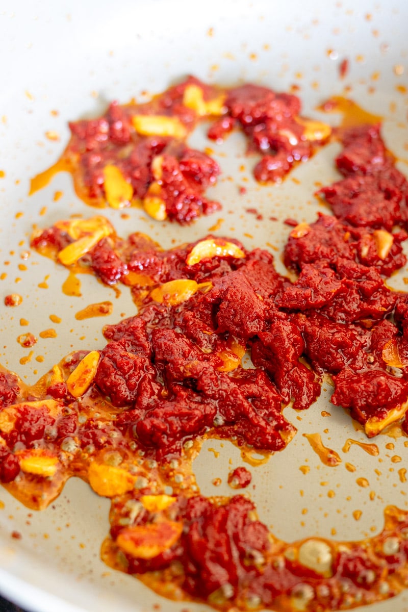 garlic and tomato paste in a pan. 