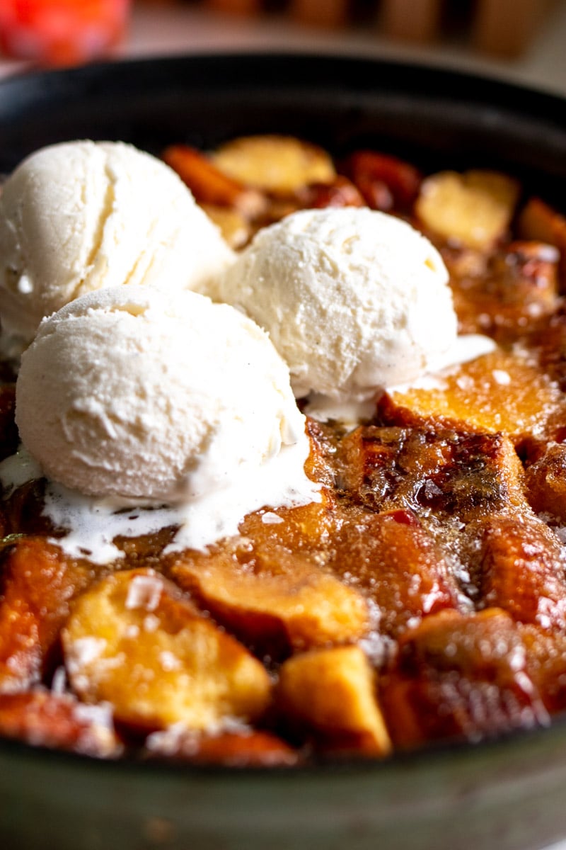 an up close view of ice cream melting on a big skillet of pretzel bread pudding.