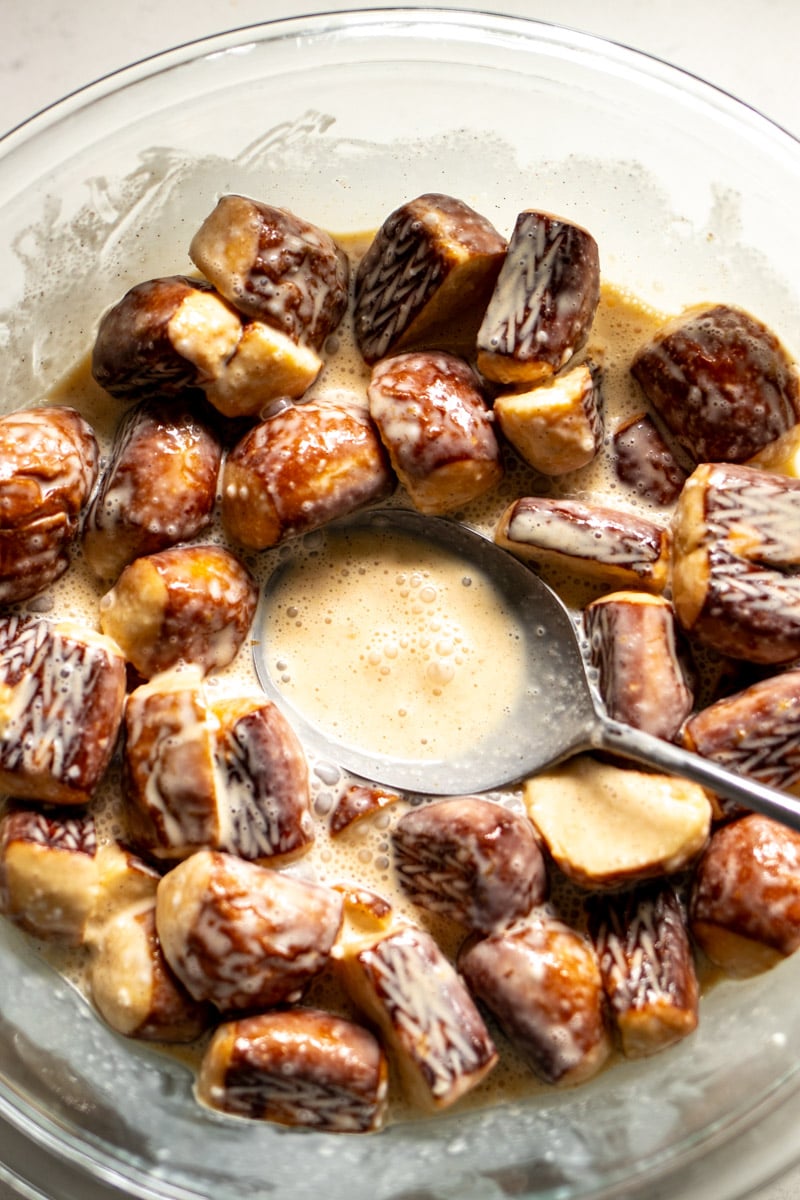 pretzels being added to custard for bread pudding. 