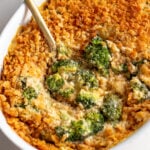 a casserole dish filled with a creamy cheesy broccoli casserole recipe.