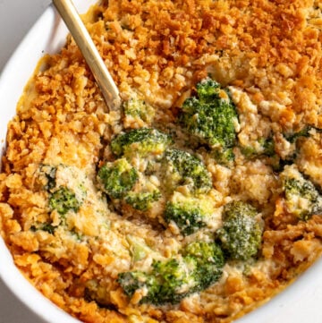 a casserole dish filled with a creamy cheesy broccoli casserole recipe.