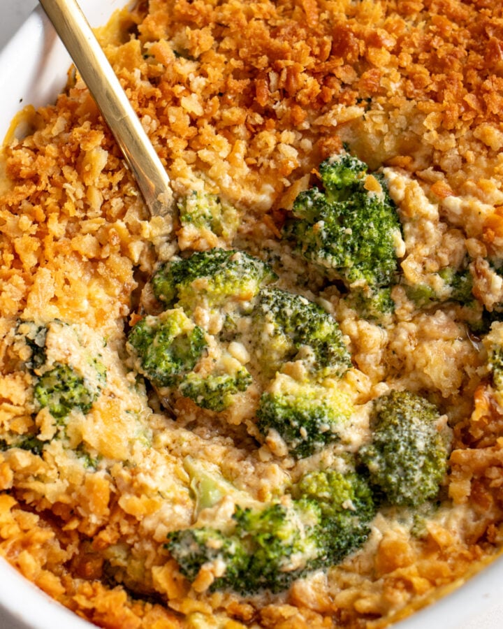 a casserole dish filled with a creamy cheesy broccoli casserole recipe.