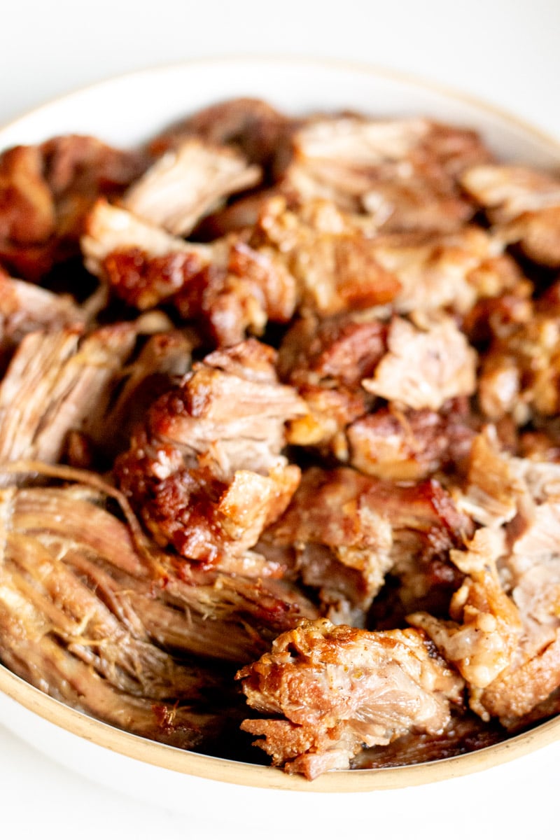 a white bowl filled with tender bbq pulled pork.