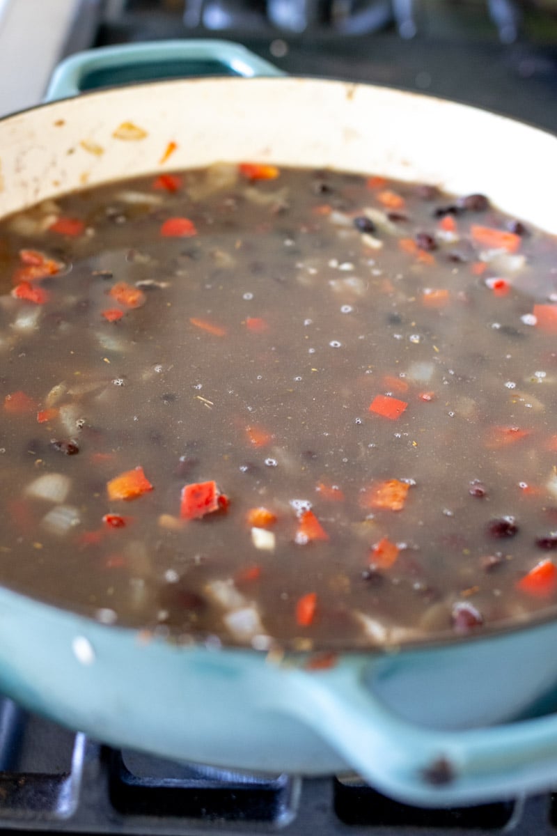 black beans and rice in broth before being cooked.