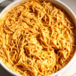 a white baking dish filled with cheesy buffalo chicken pasta.