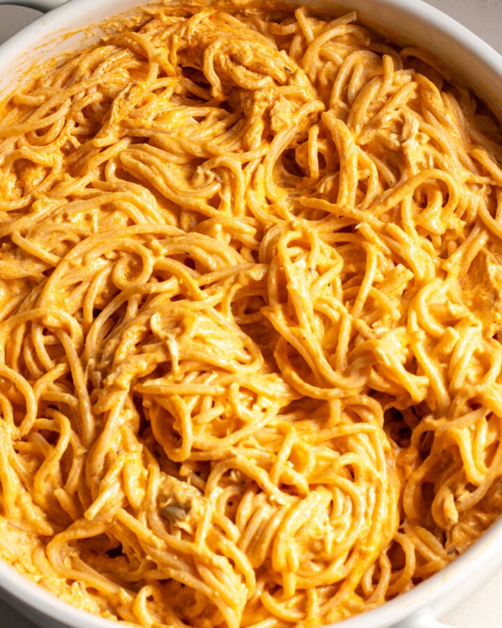 a white baking dish filled with cheesy buffalo chicken pasta.