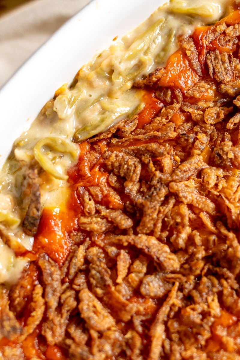 an up close view of the side of a green bean casserole showing off the crispy texture.